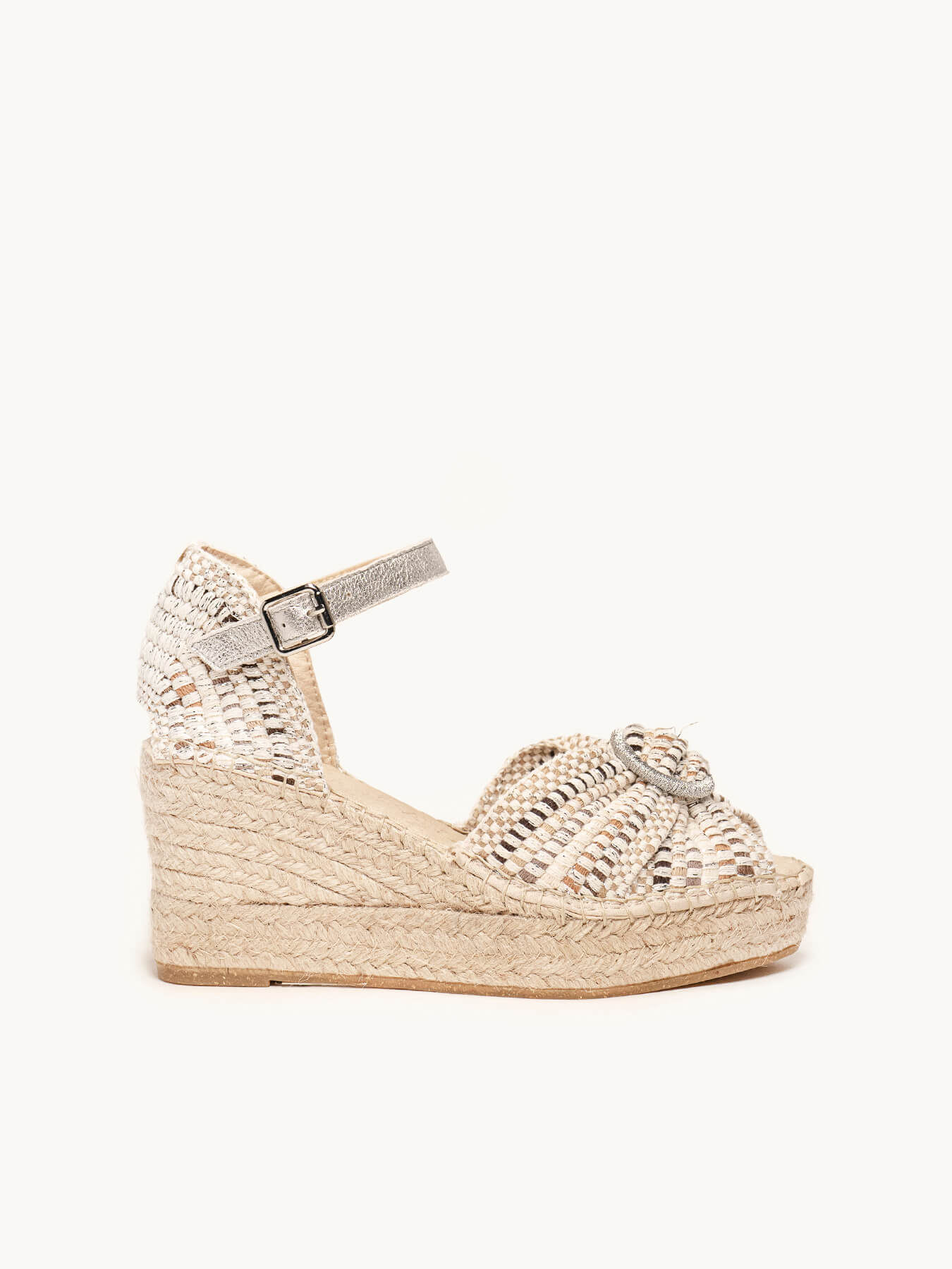 Woven wedge sandal with a strap on a white background