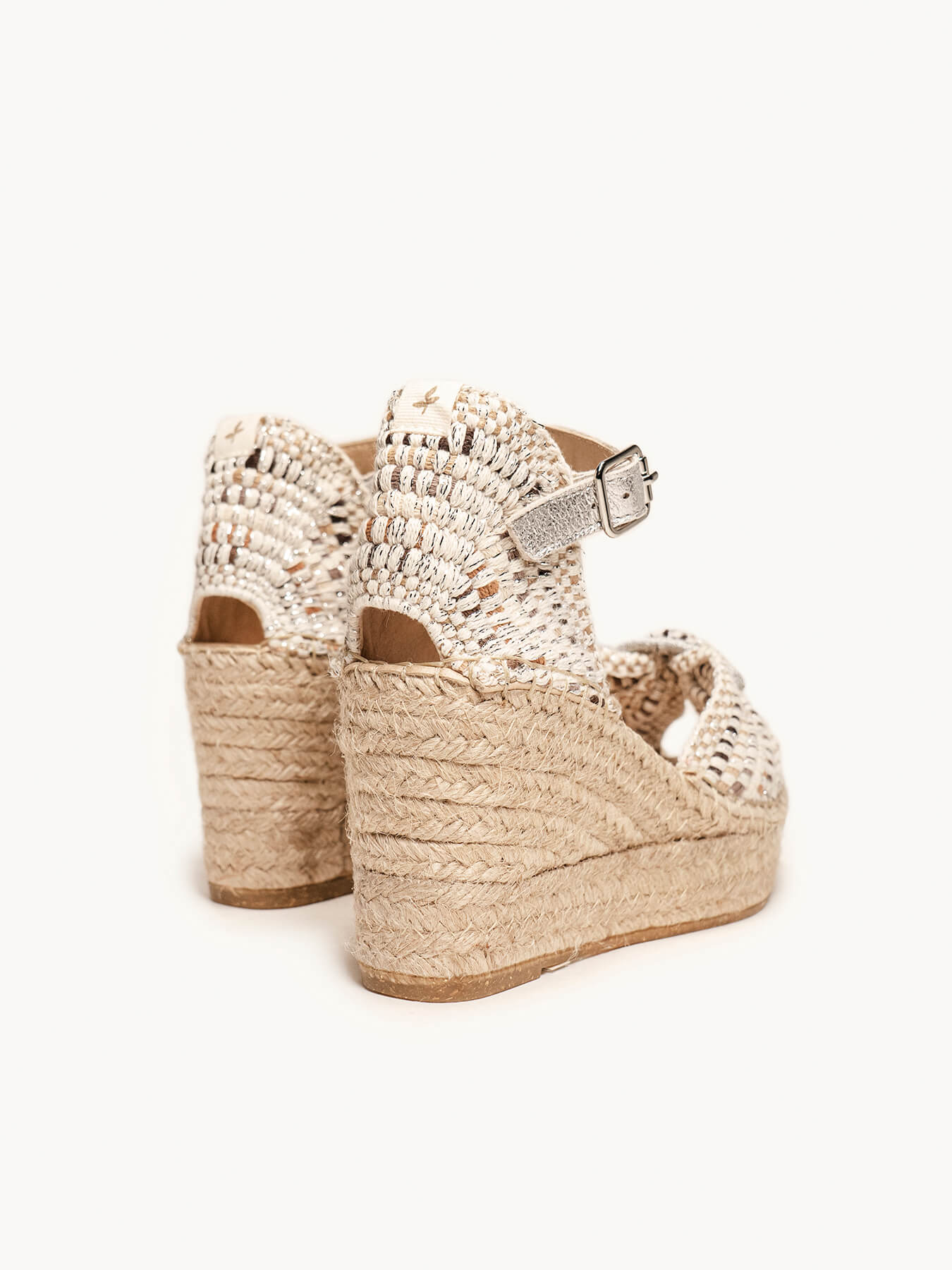 Gold wedge sandals with pearl embellishments on a white background