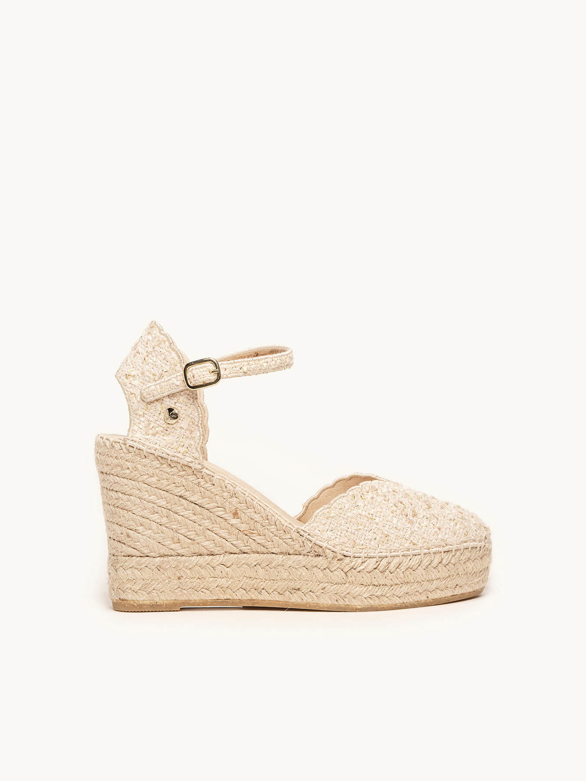 Beige wedge sandal with espadrille sole on a white background