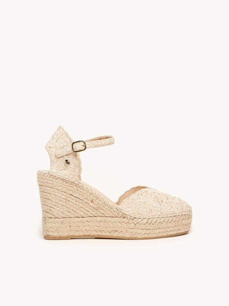 Beige wedge sandal with espadrille sole on a white background