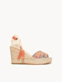 Woven wedge sandal with colorful strap on a white background