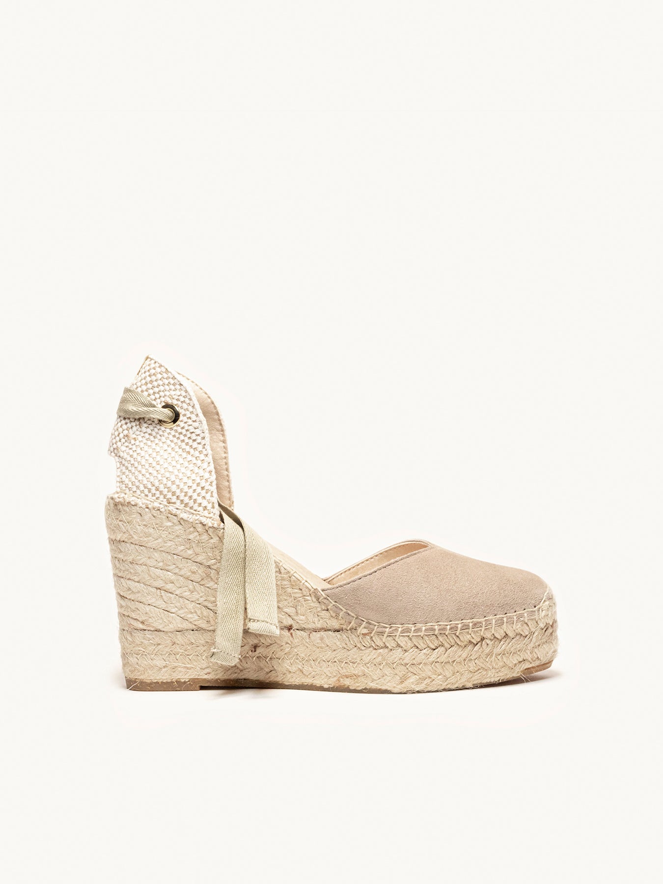 Beige wedge sandal with espadrille sole on a white background