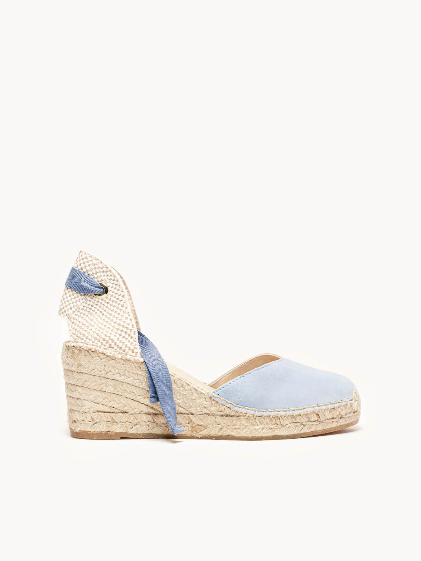 Blue wedge sandal with espadrille sole on a white background