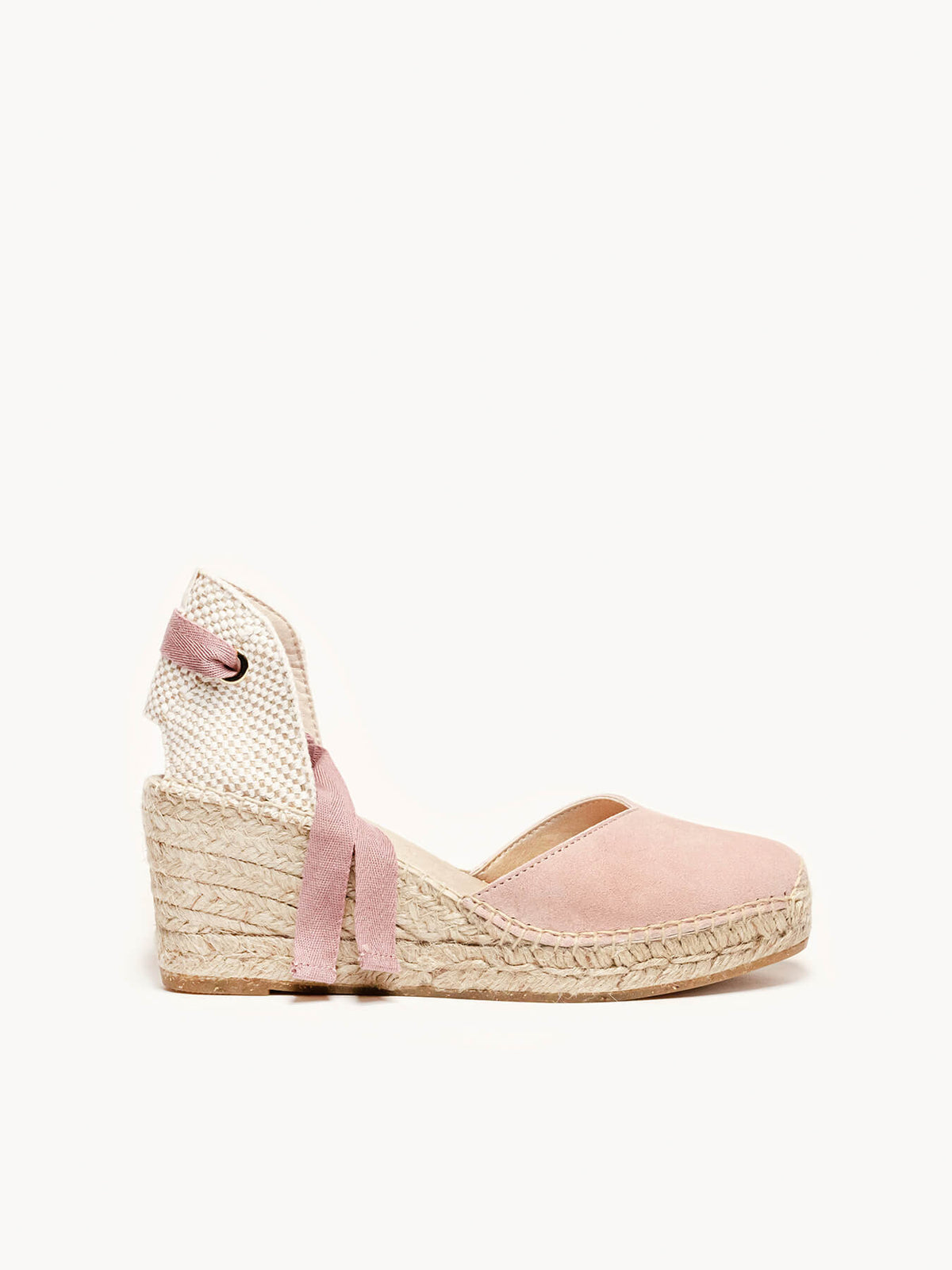 Pink wedge sandal with espadrille sole on a white background